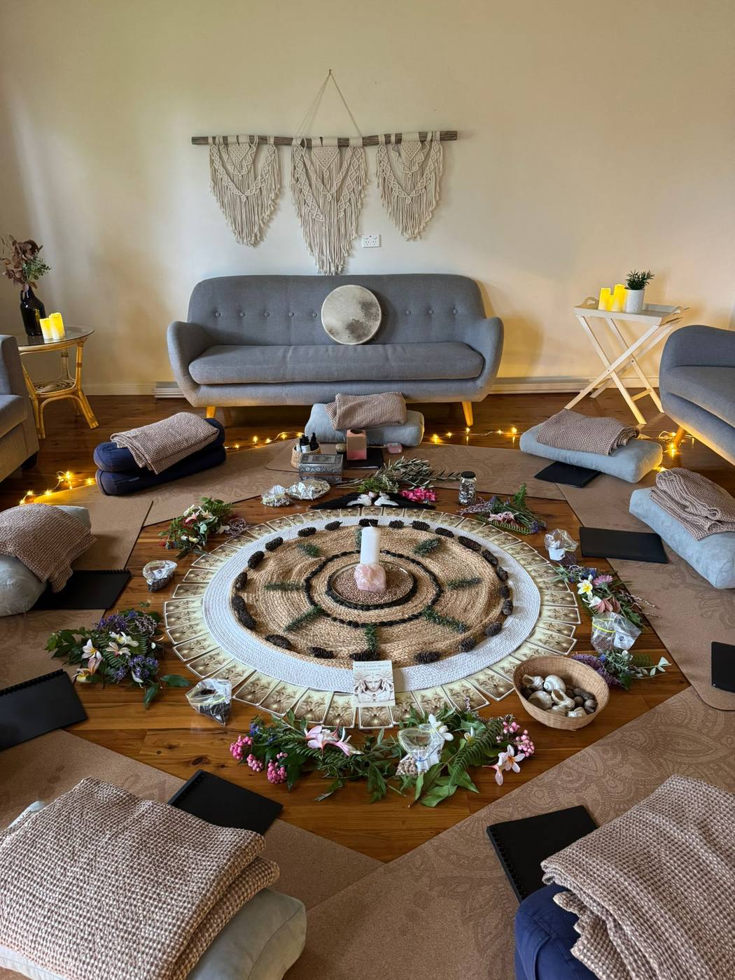 A cosy circle room with a mandala rug and candles